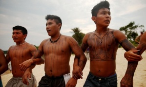  Members of the Munduruku indigenous tribe dance along the Tapajós river during a ‘Caravan of Resistance’ protest in November. Photograph: Mario Tama/Getty Images